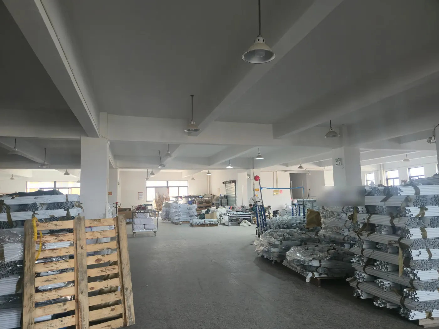 Aluminium umbrella poles stacked in the warehouse